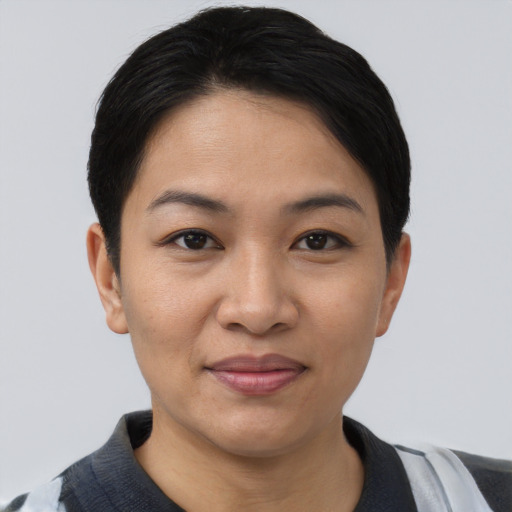 Joyful asian young-adult female with short  black hair and brown eyes
