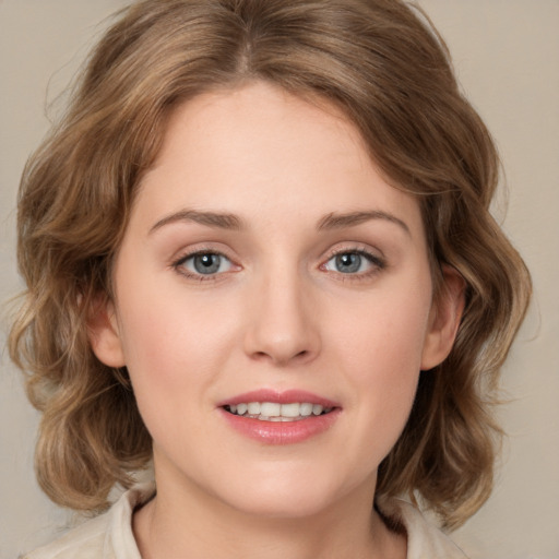 Joyful white young-adult female with medium  brown hair and grey eyes