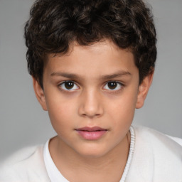 Joyful white child male with short  brown hair and brown eyes