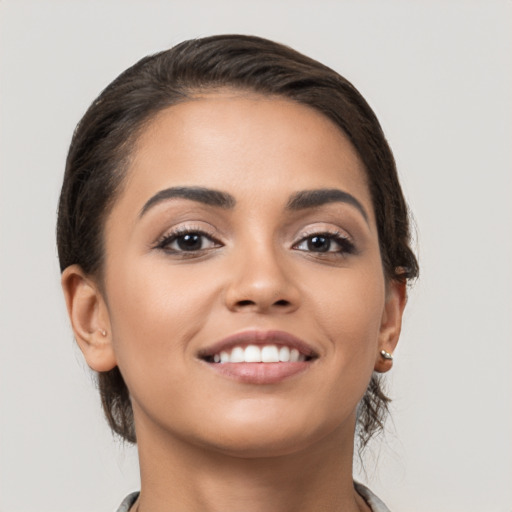 Joyful white young-adult female with medium  black hair and brown eyes