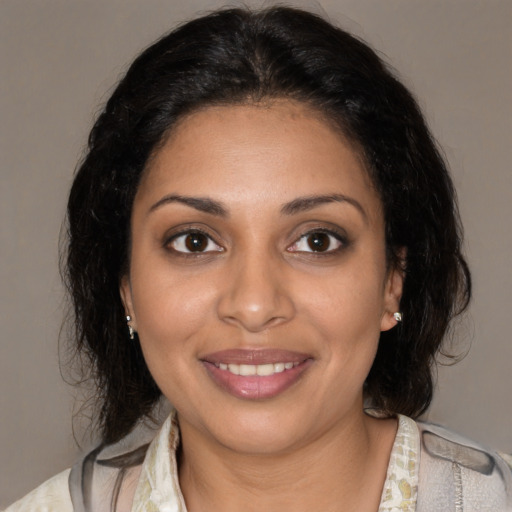Joyful black young-adult female with medium  brown hair and brown eyes