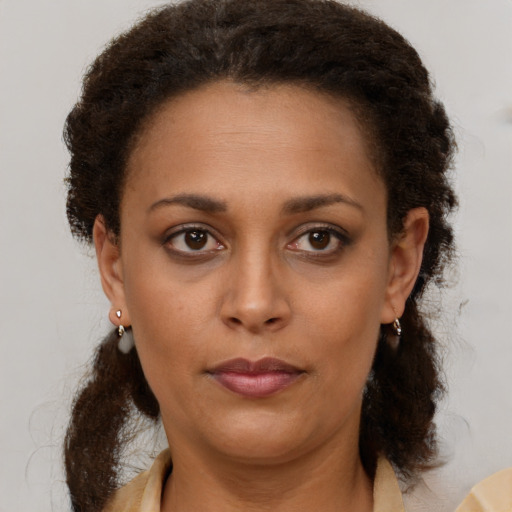 Neutral black young-adult female with medium  brown hair and brown eyes