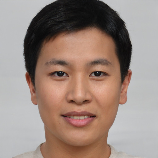 Joyful asian young-adult male with short  brown hair and brown eyes