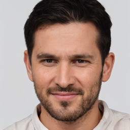 Joyful white young-adult male with short  brown hair and brown eyes