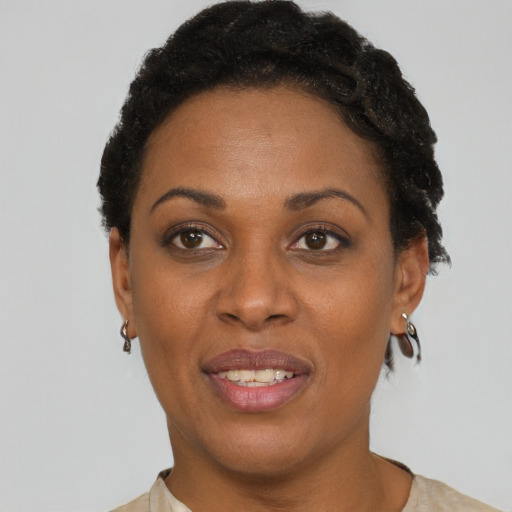 Joyful black adult female with short  brown hair and brown eyes