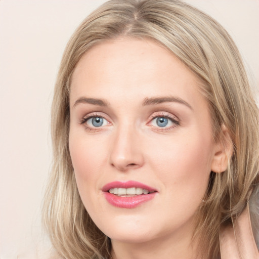 Joyful white young-adult female with long  brown hair and blue eyes