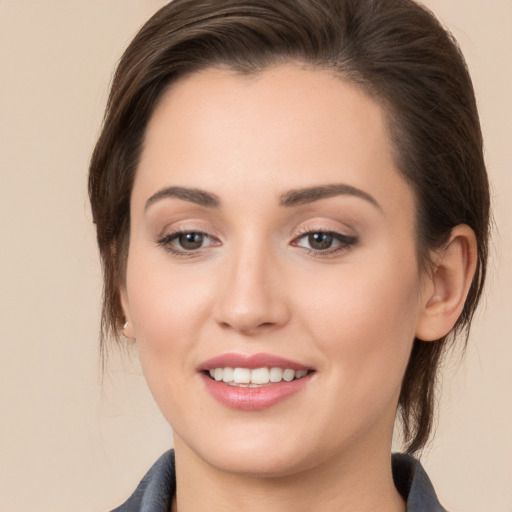 Joyful white young-adult female with medium  brown hair and brown eyes