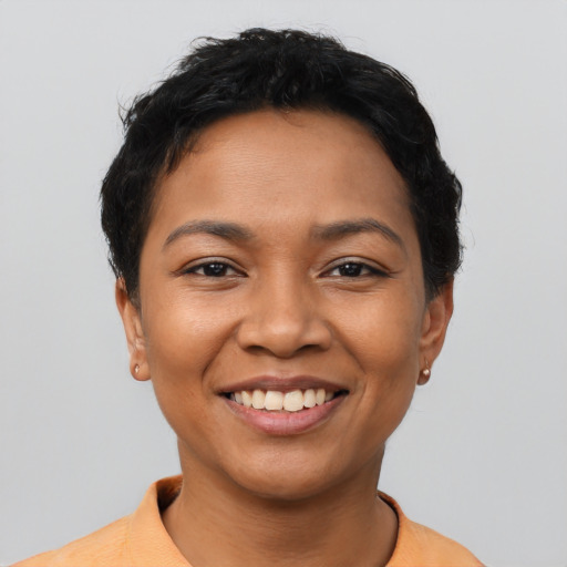 Joyful latino young-adult female with short  black hair and brown eyes