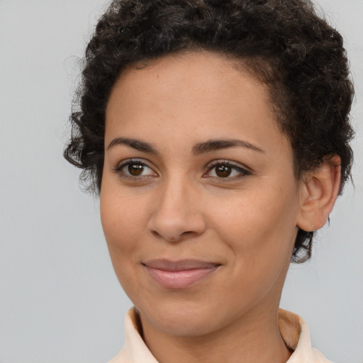 Joyful latino young-adult female with short  brown hair and brown eyes