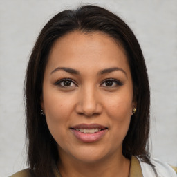 Joyful latino young-adult female with medium  brown hair and brown eyes