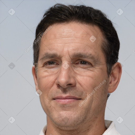 Joyful white middle-aged male with short  brown hair and brown eyes