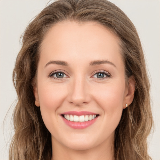 Joyful white young-adult female with long  brown hair and green eyes