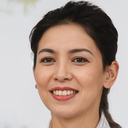 Joyful white adult female with medium  brown hair and brown eyes