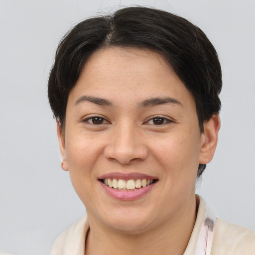 Joyful white young-adult female with short  brown hair and brown eyes