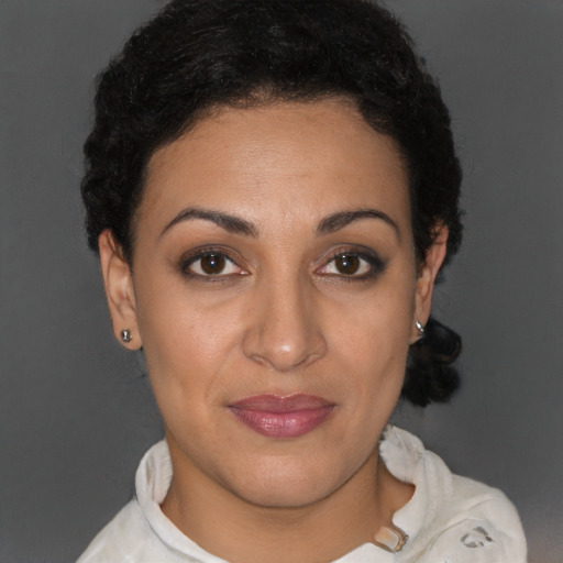 Joyful latino young-adult female with short  brown hair and brown eyes