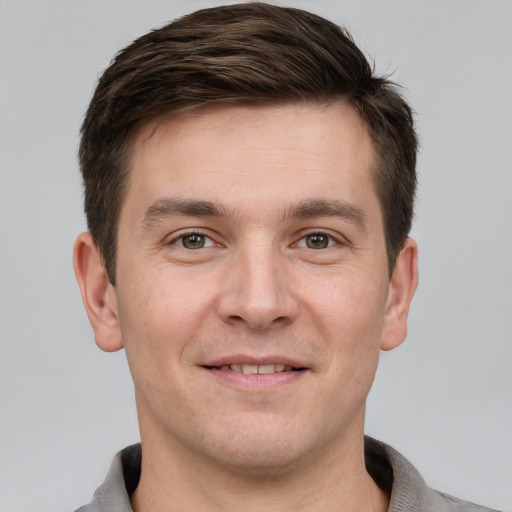 Joyful white young-adult male with short  brown hair and brown eyes