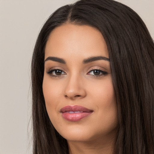 Joyful latino young-adult female with long  black hair and brown eyes