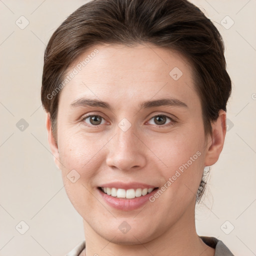 Joyful white young-adult female with short  brown hair and grey eyes