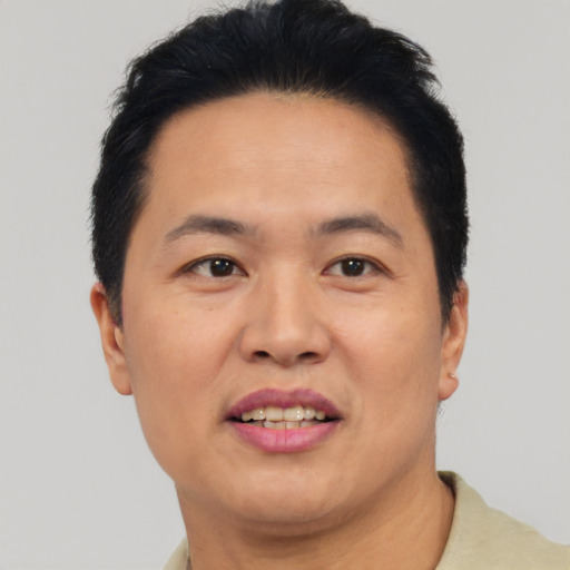 Joyful asian adult male with short  black hair and brown eyes