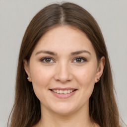 Joyful white young-adult female with long  brown hair and grey eyes