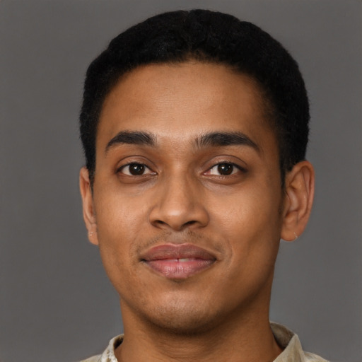 Joyful black young-adult male with short  black hair and brown eyes