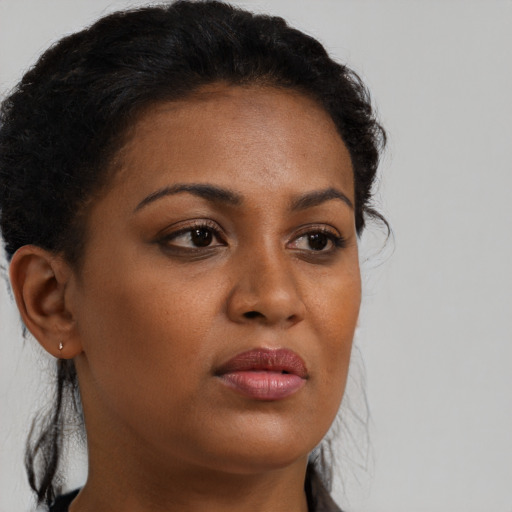 Neutral black young-adult female with long  brown hair and brown eyes