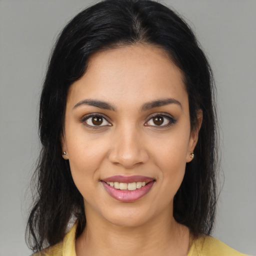 Joyful latino young-adult female with medium  brown hair and brown eyes