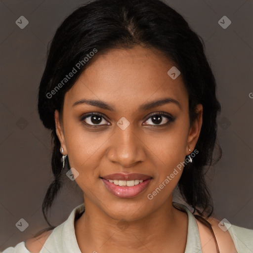 Joyful black young-adult female with long  black hair and brown eyes