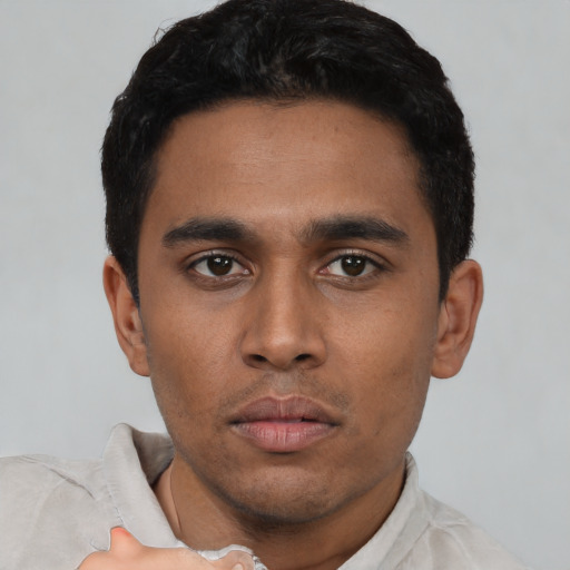 Neutral latino young-adult male with short  black hair and brown eyes