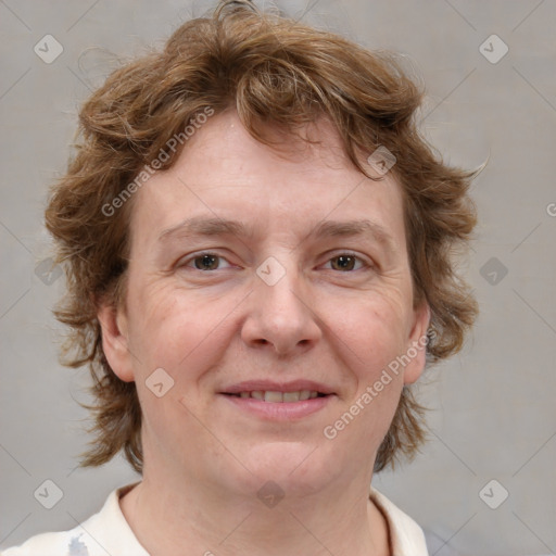 Joyful white adult female with medium  brown hair and blue eyes