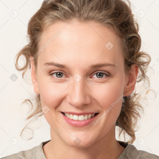 Joyful white young-adult female with medium  brown hair and blue eyes