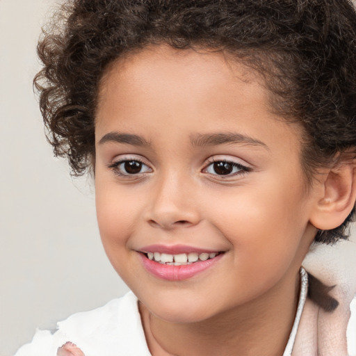 Joyful white child female with short  brown hair and brown eyes