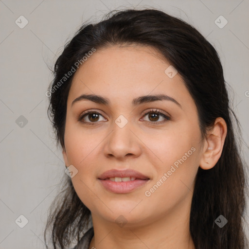 Joyful latino young-adult female with long  brown hair and brown eyes