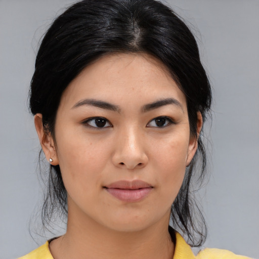 Joyful asian young-adult female with medium  black hair and brown eyes