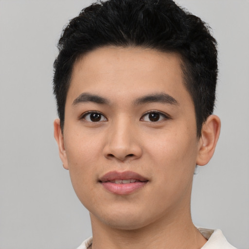 Joyful asian young-adult male with short  black hair and brown eyes