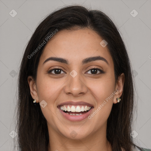 Joyful latino young-adult female with long  brown hair and brown eyes