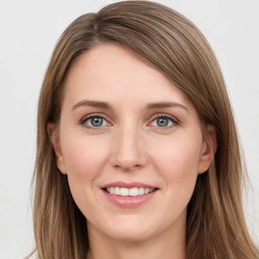 Joyful white young-adult female with long  brown hair and grey eyes