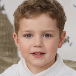 Joyful white child male with short  brown hair and brown eyes