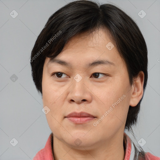 Joyful asian adult female with medium  brown hair and brown eyes