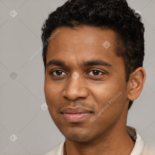 Joyful black young-adult male with short  black hair and brown eyes