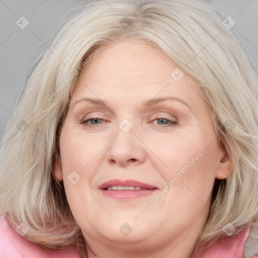 Joyful white adult female with medium  brown hair and blue eyes