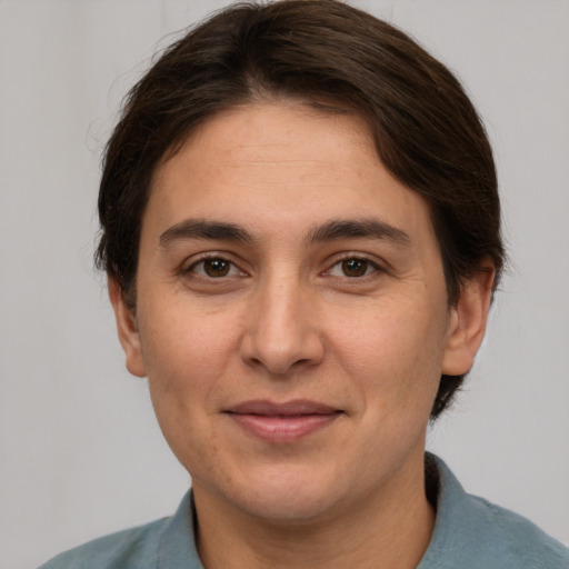 Joyful white adult female with short  brown hair and brown eyes