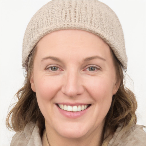 Joyful white young-adult female with medium  brown hair and blue eyes