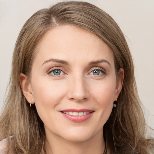 Joyful white young-adult female with long  brown hair and grey eyes