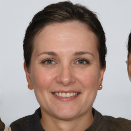 Joyful white adult female with short  brown hair and brown eyes