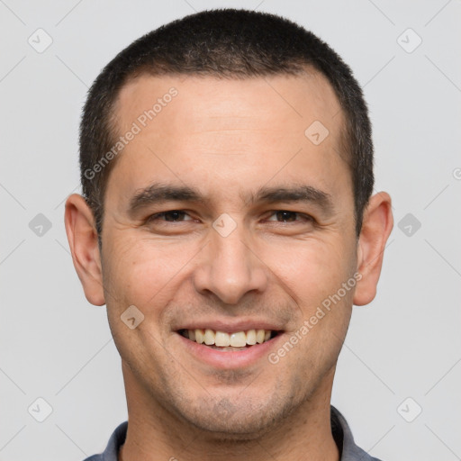 Joyful white young-adult male with short  brown hair and brown eyes