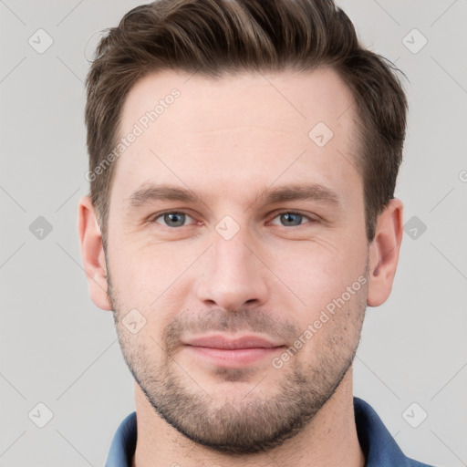 Joyful white young-adult male with short  brown hair and grey eyes