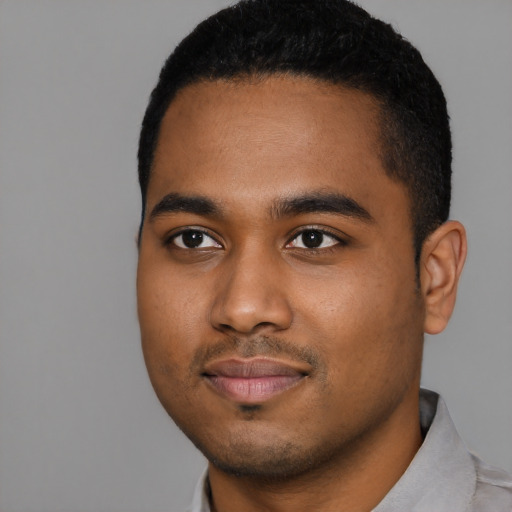 Joyful black young-adult male with short  black hair and brown eyes