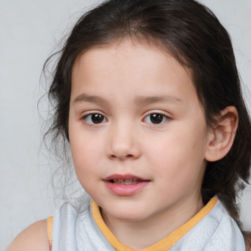 Joyful white child female with medium  brown hair and brown eyes