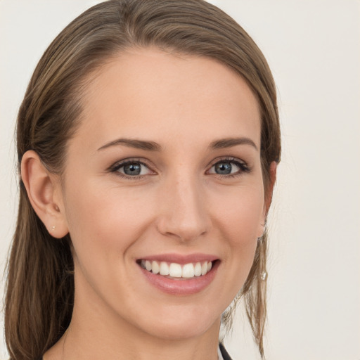 Joyful white young-adult female with long  brown hair and grey eyes